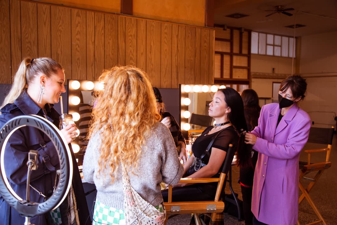 Behind the scenes photo 53 from Clone Cops production showing costume designer hannah schmidt, makeup head pam hawk, victoria keum jee, and makeup artist jennifer whitus prepare for a scene